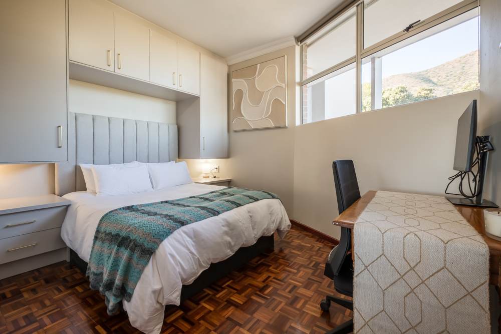 Bedroom with queen bed and desk