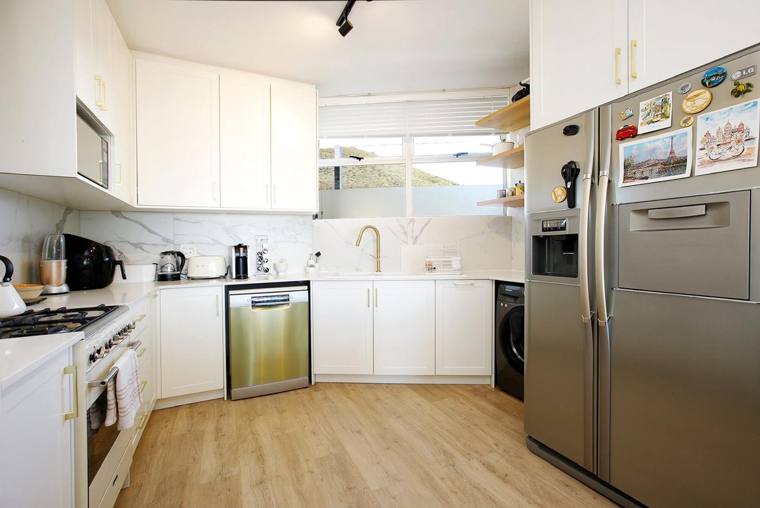 Kitchen with fridge-freezer and washing machine